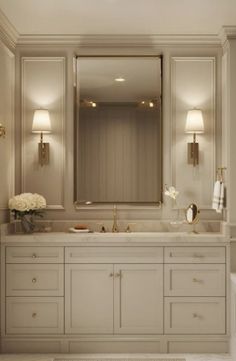 a large bathroom with two sinks and mirrors