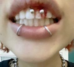 a person with piercings on their teeth