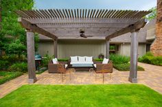 an outdoor living area with seating and pergolated patio furniture in the foreground