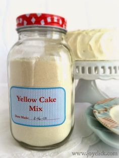 there is a yellow cake mix in a glass jar next to a plate and fork