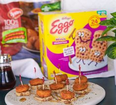 snacks are arranged on a plate with toothpicks