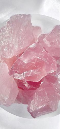 some pink crystals are on a white plate