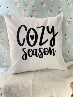 a pillow that says cozy season on it