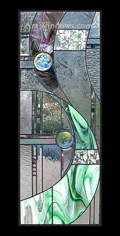 a stained glass window with an abstract design in the center and bottom part, depicting water flowing down it