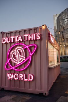 a pink shipping container with the words outa this world on it's side