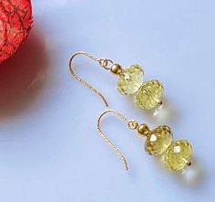 Stunningly Beautiful Earrings handcrafted with Natural laser faceted Lemon Quartz. These sparkly and Radiant clear stones look super elegant on Faceted French Earwires ! Subtle lemon color makes it wearable with any outfit . 10 mm Lemon Quartz 14K Gold Filled Earwires . Lemon Quartz Metaphysical Properties Quartz is said to help structure, focus and amplify thoughts and information. It is also thought to transmit energy. Because the color yellow is associated with clarity, communication and happiness, lemon quartz is believed to help balance and strengthen these aspects. Tiffany Bead Bracelet, Lemon Color, Pebble Jewelry, Moonstone Pendant Necklace, Gifts For Her Birthday, Bling Earrings, Handmade Fashion Jewelry, Gemstone Jewelry Handmade, Lemon Quartz