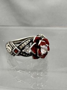 Beautiful Sterling Silver Vancaro red rose ring.   Size 5 1/2.   Weighs 5.13g If there is anything wrong once the item is received and you are not happy, please contact me before leaving negative feedback so we can resolve any issues. I strive for 100% happy buyers! Please leave positive feedback once item is received and all is well. Please feel free to ask me questions on my items! Return Policy: Buyer must contact me within 5 days of delivery to notify me of return and must ship with tracking insure within 7 days. Buyer pays return shipping and must return item with tracking. Once item is returned to me in it's original condition, a refund will be issued. Red Flower Ruby Ring For Formal Occasions, Red Flower Ruby Ring For Formal Events, Formal Red Flower Ruby Ring, Red Flower Shaped Ruby Ring For Formal Occasions, Formal Red Flower Ring, Red Sterling Silver Flower Ring As Gift, Red Flower-shaped Promise Ring, Silver Rose Detail Sterling Silver Jewelry, Red Rose Jewelry For Anniversary