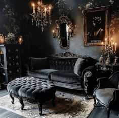 a living room filled with black furniture and chandeliers