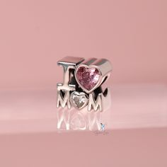 This is charm only, bracelet is sold separately. Give your mother this meaningful gift, the charm features the 3D word I LOVE MOM, made of solid 925 sterling silver and cubic zirconia gem stones, finished with a platinum plating to give it a high end look and long lasting shine. This mother gift charm will fit Pandora bracelet or you can check out our charm bracelet. Jewelry Care: See more information about how to care for your jewelry here. Shipping Policy: Orders will be shipped within 1-3 bus White Gold Charm Bracelet For Anniversary On Mother's Day, Cubic Zirconia Charm Bracelet Gift, Elegant Sterling Silver Charms For Mother's Day, Silver Jewelry For Valentine's Day, Sterling Silver Jewelry With Removable Charms For Mother's Day, Sterling Silver Jewelry For Mother's Day, Diamond Charms With Diamond Accents For Gifts, Personalized White Gold Charms For Mother's Day, Pink Charms For Mother's Day