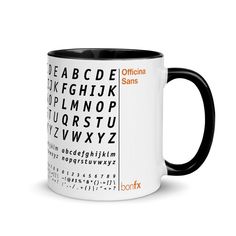 a black and white coffee mug with the alphabet in it's center, on a white background