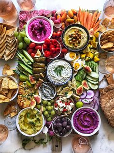 a table full of different types of food and drinks on it, including dips