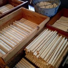 an open box filled with lots of wooden dows on top of a table next to other boxes