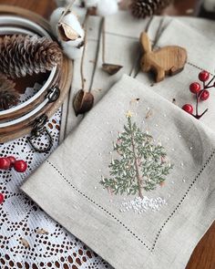 a table topped with christmas decorations and napkins