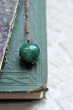 This listing is for elegant Heart of the Forest Necklace. Simple and natural, features beautiful emerald green gemstone.  The rich green color symbolizes growth, renewal, and harmony, perfect for those who embrace a natural and bohemian vibe. The design is simple yet captivating, allowing the deep green gemstone to be the central point. Thanks to this beautiful emerald green gemstone, I decided to call it "Heart of the Forest". With its earthy and enchanting feel, this necklace is ideal for anyone who wants to bring a bit of forest magic into their style. measurements: width of the pendant - 1,1 inches (2,8 cm) measurements: Please choose your chain options - the price for each option is different (please check while adding it to your cart) No chain (just the pendant) 18 inches (46 cm) 25 Green Crystal Necklaces For May Birthstone, Green Spiritual Necklace With Birthstone, Green Jade Necklaces For May Birthstone, Green Necklace For Meditation - May Birthstone, Spiritual Jade Necklace For May Birthstone, Jade Necklace For May Birthstone With Spiritual Style, Green Gemstone Crystal Necklace For Meditation, Spiritual Green Necklace For May Birthstone, Spiritual Green Round Pendant Crystal Necklace