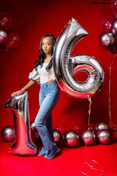 a woman posing with balloons and a number six balloon in front of red background for an advertisement