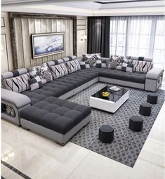 a living room filled with lots of couches and pillows on top of a rug