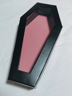 an empty black box with pink liquid inside