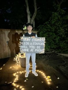 a man holding a sign that says every starboy needs a stargirl will you be mine at prom?