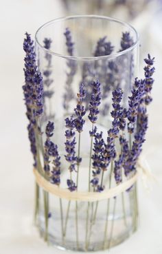 a glass vase filled with lavender flowers on top of a wooden table next to an instagram page