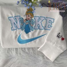 Introducing our Personalized Cinderella Disney Nike Embroidered Sweatshirt, the perfect Christmas present for couples! This enchanting sweatshirt combines the magic of Disney with the iconic Nike brand, creating a truly unique and meaningful gift. The sweatshirt features a beautifully embroidered Cinderella design, personalized with the couple’s names, adding a touch of romance and personalization. Made from high-quality materials, it offers exceptional comfort, warmth, and durability. Whe Couple Christmas Presents, Cinderella Design, Nike Embroidered Sweatshirt, Disney Nike, Couple Presents, Embroidered Shirts, Cinderella Disney, Christmas Gifts For Couples, Birthday Gift For Women