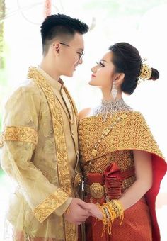 a man and woman dressed in traditional thai garb