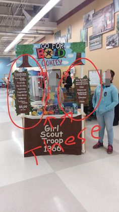 a woman standing in front of a counter with information on it and two red arrows pointing to the right