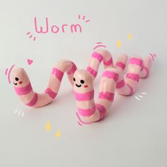 pink and white candy worms are lined up in the shape of letters w, m, n