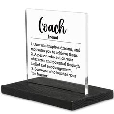 a clear acrylic plaque with the words coach on it and an inscription below that reads, one who inspires streams, and motivates you to achieve them