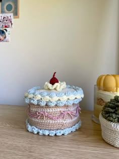 three crocheted baskets sitting on top of a wooden table next to each other