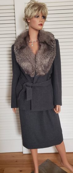 This exquisite warm gray soft wool suit features a luxurious genuine fox collar. The wrap front jacket is belted, has two front pockets and is fully lined in gray silky fabric.  The matching back slit skirt has two side pockets, a back zipper/button closure and is also fully lined.   The suit was made in the USA and has a red, white and blue ILGWU (1974-1995) label.  The suit is labeled a size 10.  It does not have any manufacturer labels, but is a very high end piece. This beautiful suit would Fox Collar, Wardrobe Measurements, Jacket Suit, Beautiful Suit, Wrap Jacket, Wool Wrap, Silky Fabric, Wool Suit, Warm Grey