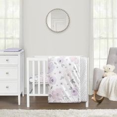 a baby's room with white furniture and flowers