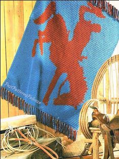 a blue and red afghan sitting on top of a wooden chair