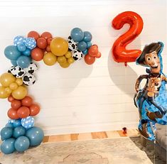 a toy story birthday party with balloon decorations and balloons in the shape of numbers 2