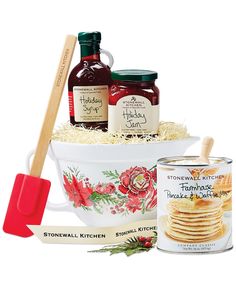 the holiday gift basket includes jams, crackers, and breadsticks in a white bowl