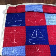 a crocheted blanket with letters on it