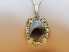 In good vintage condition. Unknown maker.  Polished agate rock in gold filled setting. Please look at the pictures for details and condition because the exact item pictured is the exact item that you will receive. Gold Agate Oval Pendant Necklace, Gold Agate Necklace With Oval Pendant, Antique Gold Agate Jewelry, Vintage Gold Agate Jewelry, Agate Rock, Agate Rocks, Chain Choker Necklace, Chain Choker, Semiprecious Stones