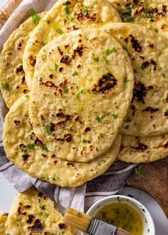 several flatbreads on a plate with dipping sauce