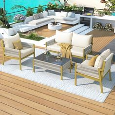 an outdoor living area with white furniture and blue water in the backgroung