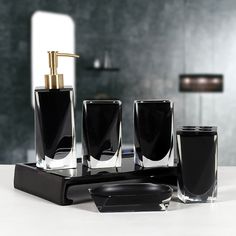 a bathroom set with soap dispenser, toothbrush holder and other items