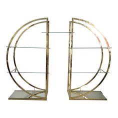 a pair of metal and glass bookshelves sitting on top of each other in front of a white background