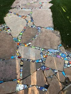 a walkway made out of different colored glass tiles