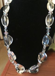 Lucite Beads with rainbow crystals gives this light weight clear necklace a sparking translucent look. This necklace measures 13 and 1/2 inches. The clasp is silver with a heart accent. Jewelry 2024, Clear Necklace, Druzy Necklace, Jewellery Sets, Rainbow Crystal, Crystal Chain, Beaded Necklaces, Stone Necklace, Chain Styles