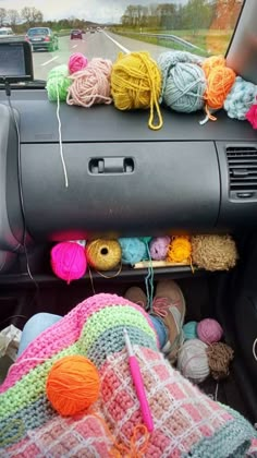 the interior of a car with balls of yarn and crochet