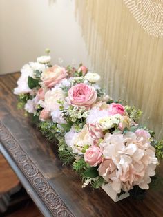 the flowers are arranged on the wooden table