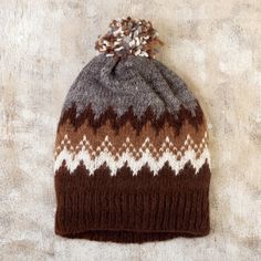 Peru's Maria Esperanza Jauregui designs a hat inspired by the mountains of Puno and their exquisite colors. Brown, camel, grey, beige and black make up the palette for this lovely unisex accessory knit from fine and soft alpaca fibers and topped with a delicate pompom. Alpaca Hat, Brown Hat, Brown Hats, Alpaca Fiber, Beige And Black, Grey Beige, Colors Brown, Unisex Accessories, Gothic Art