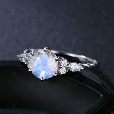 This is 7mm Round cut natural moonstone engagement ring. The accent stones are VVS man made cz diamond. The stones can be replace with other gemstones.For example,if you don't like the CZ accent,you can ask me replace it with tourmaline,aquamarine,diamond,emerald,sapphire... For custom making jewelry,it can be made in 2 different metal(Please contact me if you need this one made in solid gold). 1,Solid gold,including 14/18k white/rose/yellow gold. 2,925 sterling silver with white/yellow/rose gol Round Moonstone Ring For Anniversary, Round Cut Moonstone Ring In White Gold, Anniversary Diamond White Moonstone Ring, Moonstone Anniversary Ring, White Gold Moonstone Ring Round Cut, Diamond White Moonstone Promise Ring, Round Moonstone Ring In Diamond White, Diamond White Moonstone Ring, Moonstone Ring With Accent Stones