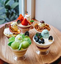 small bowls filled with different types of food on top of a wooden table next to a window