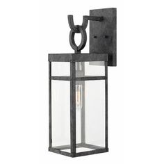 an outdoor wall light with a metal frame