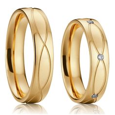 two gold wedding rings with diamonds on them