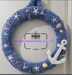 a blue wreath with an anchor, starfish and seashells